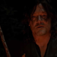 Norman Reedus as Daryl Dixon in AMC's The Walking Dead, staring into a campfire.